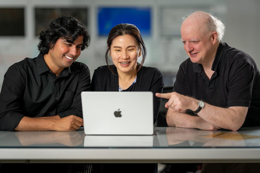 The Deep Underground Neutrino Experiment is pioneering artificial intelligent tool integration into the experiment to empower DUNE scientists and accelerate scientific discovery. Pictured, left to right, are Vishvas Pandey, Seon Hee Seo and Thomas Junk. Credit: JJ Starr, Fermilab