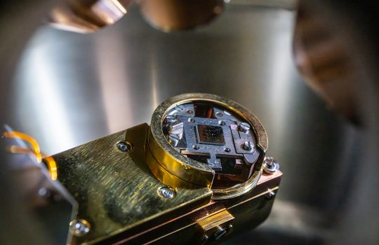 Superconducting qubit chip seen inside the X-ray photoelectron spectroscopy analysis chamber. Using XPS, researchers can understand the chemical composition of oxides present at the surface of the devices. Credit: JJ Starr, Fermilab