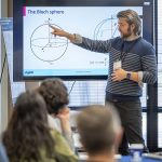 Quantum 101- during Exploring the Quantum Universe, attendees could participate in entry level lectures and demonstrations of quantum programs. Andrew Bestwick (Rigetti Computing), teaches a session on qubit measurements and quantum processors.