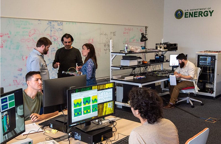 Researchers in the control room of the SQMS Quantum Garage facility, developing architectures and gates for SQMS hardware tailored toward HEP quantum simulations. From left to right: Nick Bornman, Hank Lamm, Doga Kurkcuoglu, Silvia Zorzetti, Julian Delgado, and Hans Johnson. Photo credit: Hannah Adams Brumbaugh, Fermilab
