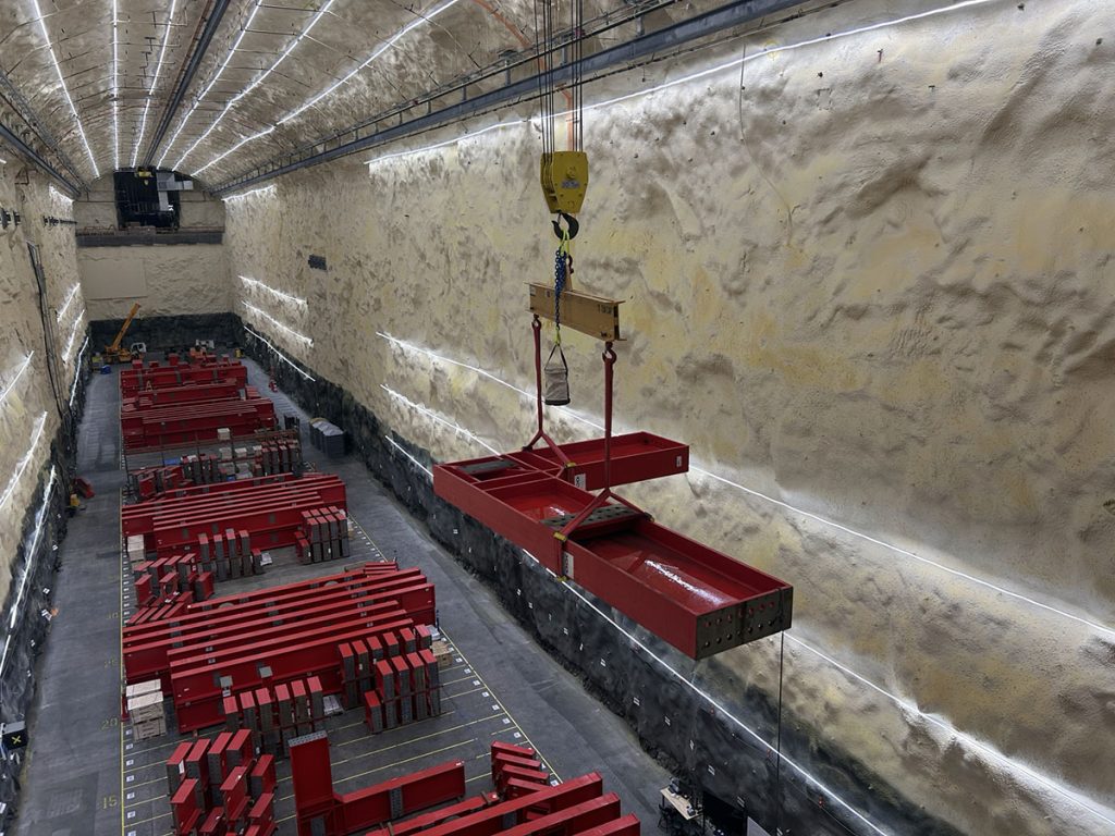 An L-beam for a DUNE cryostat is moved in the south cavern, which is nearly a mile below the surface at the Sanford Underground Research Facility. The research space, more than 500 feet long and about seven stories tall, will house one of the experiment’s massive detector modules. Credit: Aaron Thompson, Fermilab